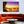 Modern living room with orange sofa, round table, and vibrant sunset beach wall art