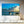 Modern living room with large wall art of boats on water at sunset, luxury interior decor