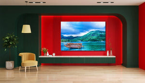 Modern living room with yellow chair, potted plant, and large wall art of tropical lake landscape
