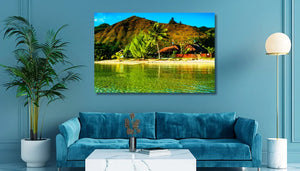 Tropical beach landscape wall art above blue velvet sofa in modern living room