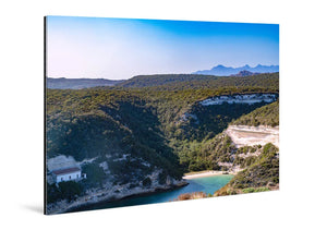 Acrylic photo print of a scenic coastal landscape with green hills, blue sky, and turquoise bay.