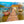 Acrylic photo print of a tropical dock with boats, clear water, and a thatched-roof hut.