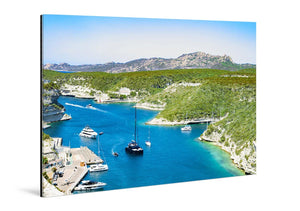 Acrylic photo print featuring a vivid harbor scene with yachts on turquoise water and green hills.