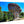 Acrylic photo print of a mushroom-shaped rock formation with trees under a blue sky.