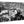 Black and white acrylic photo print of a city scene with a statue, historic buildings, and crowd