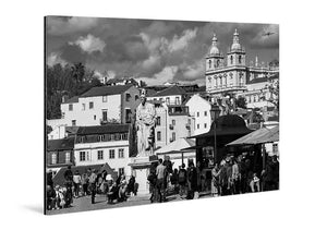 Black and white acrylic photo print of a city scene with a statue, historic buildings, and crowd