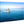 Glossy acrylic photo print of people in a small boat on calm blue ocean water