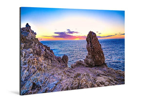 Acrylic photo print of a rocky seaside cliff at sunset, vibrant ocean and sky colors