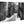 Black and white acrylic photo print of a European street with tram tracks and pedestrians.