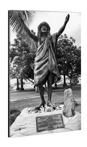 Black and white acrylic photo print featuring a joyful statue with arms raised in a park setting
