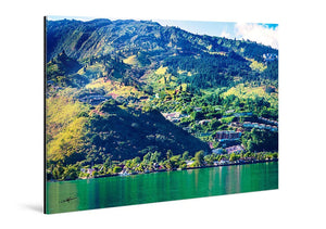 Glossy acrylic photo print featuring a vibrant mountain landscape with green hills and water.