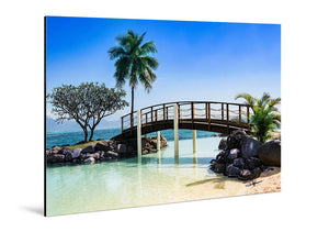Aluminum photo print of tropical beach with wooden bridge, palm trees, blue sky, and clear water