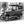 Black and white photo of a vintage car parked on a city street, printed on glossy aluminum Dibond.