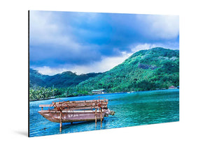 Glossy aluminum photo print of a tropical boat on blue water with lush green mountains