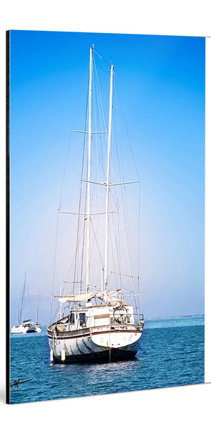 Glossy aluminum Dibond wall art featuring a sailboat on calm blue sea under clear sky