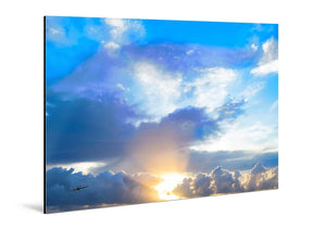 Glossy aluminum photo print of sun rays shining through dramatic clouds in a blue sky
