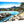 Aluminum photo print of a sunny beach scene with blue water, palm trees, and rocky shoreline.