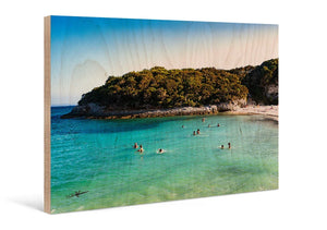 Direct print on wood featuring a beach scene with turquoise water and people swimming.