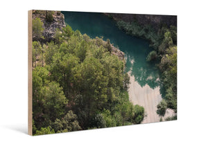 Direct print on wood featuring a landscape with trees and a river