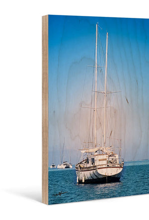 Boat photography printed on wood panel, featuring sailboats on calm blue water.