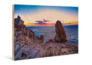 Scenic sunset seascape photograph printed on wood, featuring rocky cliffs and ocean view.