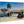 Tropical beach bridge scene printed on wood, featuring palm trees and clear blue water