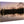 Fine art print on wood featuring a serene lake with trees reflected at dusk.