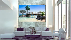 Modern living room with large tropical landscape wall art, bridge over water, palm trees, white sofa