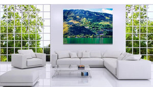 Modern living room with white sofas, large landscape wall art, and floor-to-ceiling windows