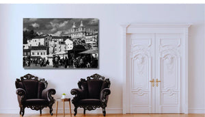 Elegant living room with ornate black armchairs and a black and white cityscape wall art above.