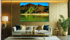 Modern living room with tropical landscape wall art, plush sofa, and gold accents