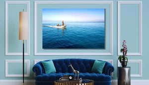 Elegant living room with blue velvet sofa and wall art of two people in a boat on calm ocean
