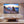 Modern living room with large wall art of a rocky seaside sunset and calm ocean view
