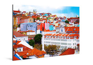 Colorful cityscape with red-tiled roofs and historic buildings under blue sky
