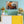 Modern living room with wall art featuring a hermit crab on sandy beach above yellow cabinet