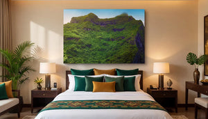 Modern bedroom with green and gold decor, large wall art of lush mountain landscape above bed.