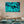 Modern living room with underwater ocean art print on wall, neutral decor, blue rug
