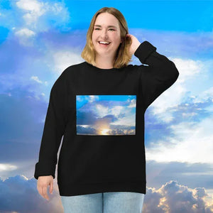 Smiling woman in black sweatshirt with artistic sky photo print, blue sky background