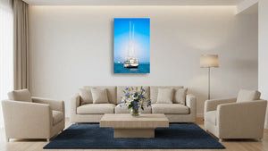 Modern living room with beige furniture, blue rug, and sailboat wall art on white wall
