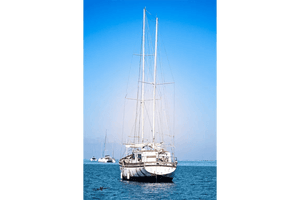 Sailboat on calm blue sea with clear sky, fine art nautical photography