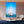 Modern living room with large wall art featuring a sailboat on blue sea, minimalist decor