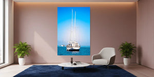 Modern living room with large wall art featuring a sailboat on blue sea, minimalist decor