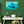 Tableau décoratif raie manta sous l’eau turquoise accroché dans un bureau moderne verdoyant