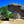 Large mushroom-shaped rock formation in a forest under clear blue sky