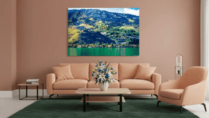 Mountain landscape plexiglass wall art above peach sofa in modern living room
