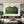 Large acrylic wall art featuring a lush green mountain landscape in a modern living room