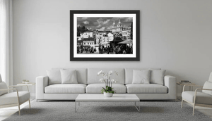 Modern living room with neutral decor featuring large black and white cityscape wall art.