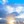 Sunrise with sun rays shining through clouds and blue sky