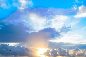 Sunrise over clouds with dramatic blue sky and sun rays, fine art photography landscape