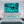 Modern bedroom with teal ocean abstract wall art above bed, matching decor and lamps